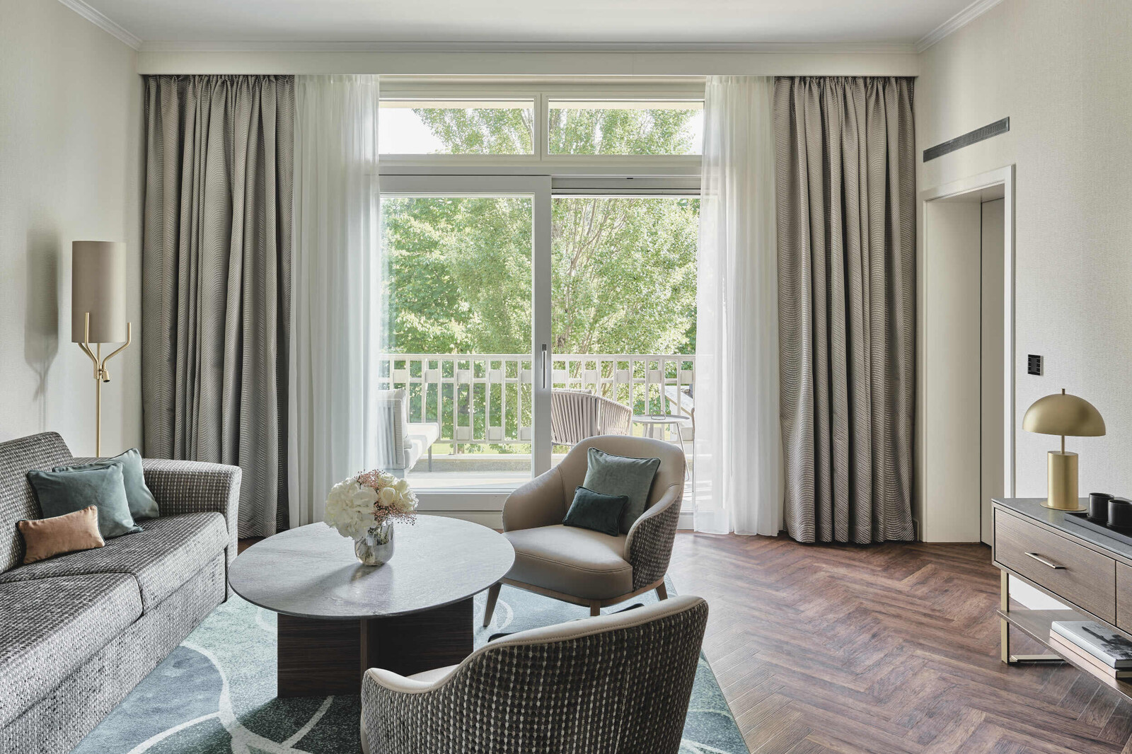View of the window front in the living room of a Grand Deluxe Suite in the Grand Hotel Hof Ragaz.