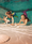 Three girls with mermaid fins collect shells under water in indoor pool.
