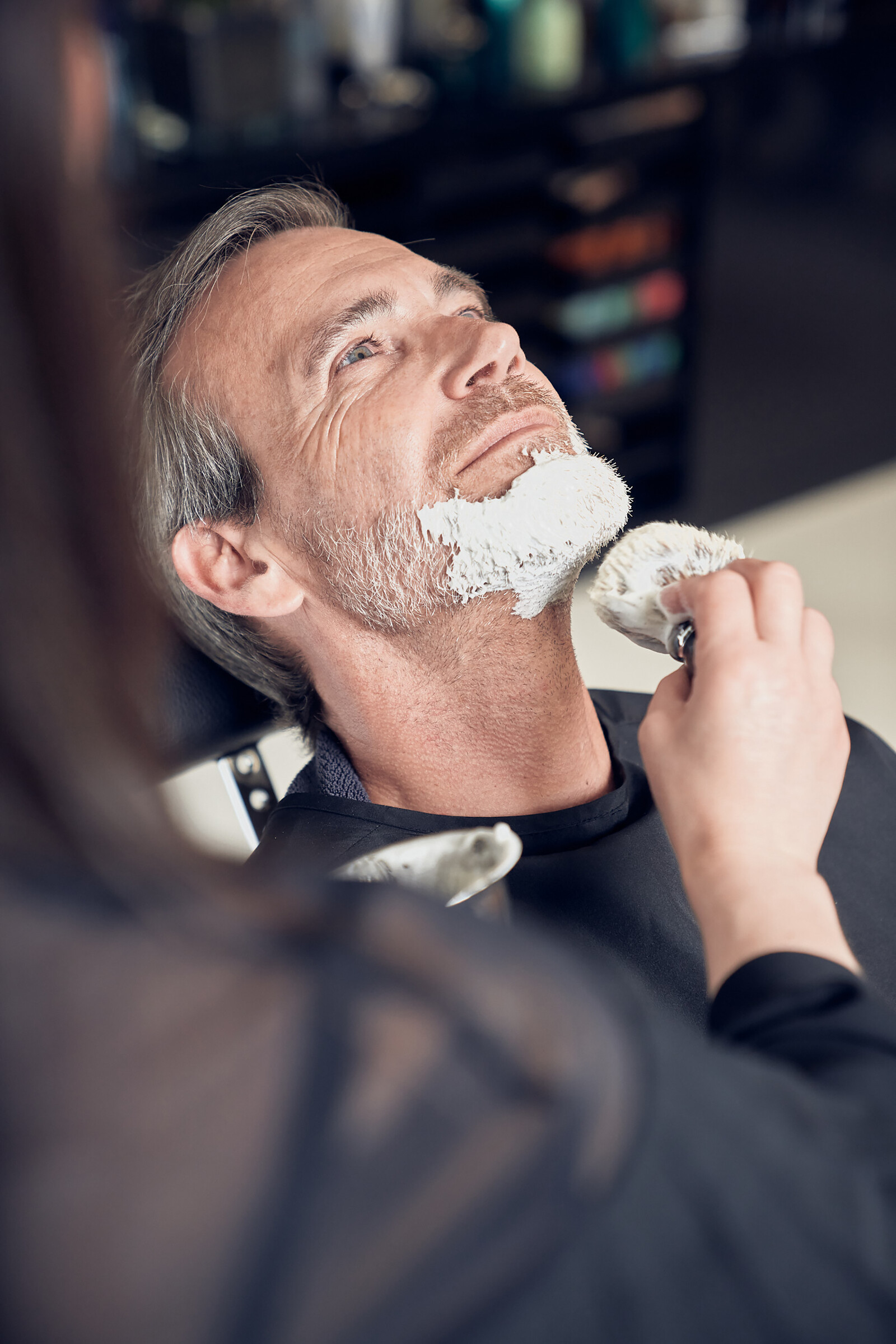 A man is prepared for beard care with beard foam.