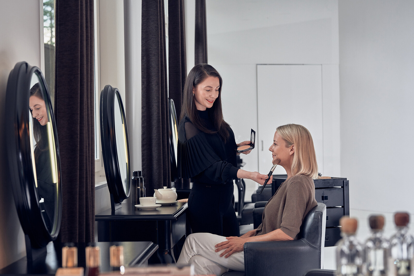 A lady is made up in the Hair Spa with light day make-up.