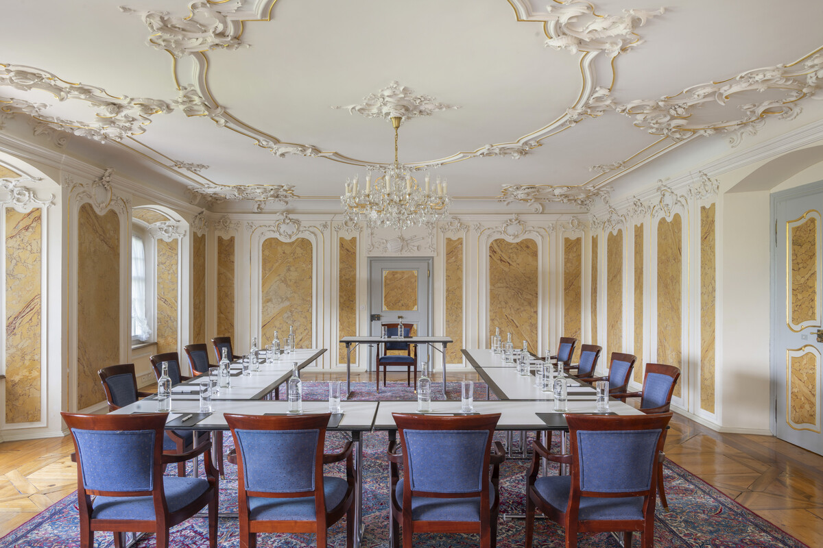 Light-flooded music salon with princely stucco marble and a conference chair cast
